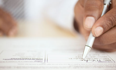 Man's hand signing a contract